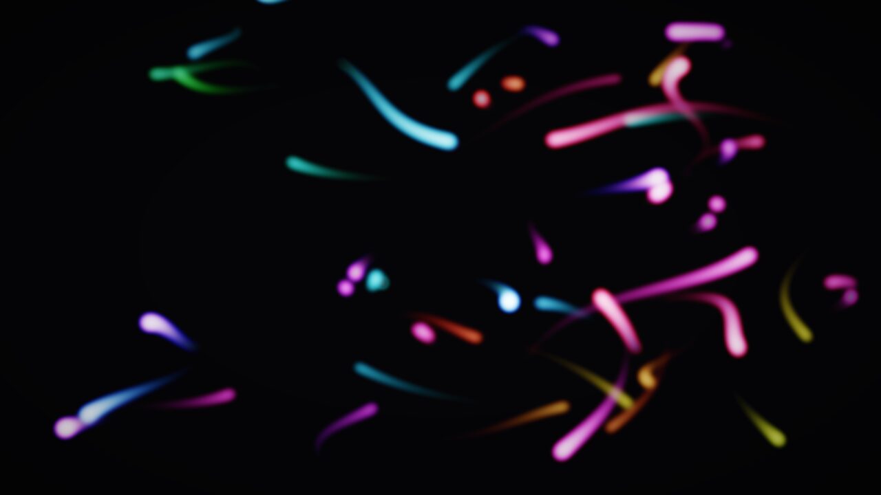 Glow Worms scene in Wobbly TV — colorful glowing streaks of light against black